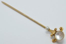 A continental 14k gold stick pin set with a moonstone and seed pearl, length 6cm, 2.1g