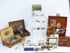 A collection of costume jewellery including badges, Cheltenham Festival of Music medals, pearls,