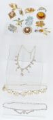 A collection of vintage brooches and necklaces