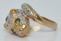 A 9ct gold ring in the form of a leopard set with diamonds, sapphires and emeralds, 4.5g, size I/J