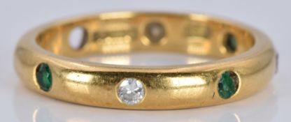 An 18ct gold eternity ring set with emeralds and diamonds, 4.3g, size M