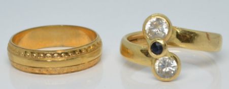 Two yellow metal rings, size O and P