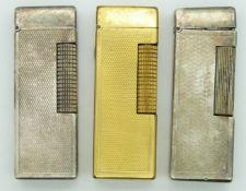 Two Dunhill Rollagas lighters and a similar petrol lighter