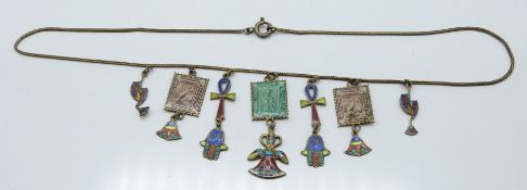 An Egyptian silver gilt necklace with various charms set with enamel, L- 37cm
