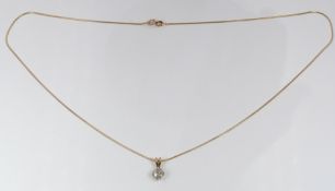 An 18ct gold pendant set with a diamond of approximately 0.45ct on a 9ct gold chain