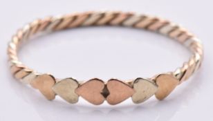 A 9ct gold tri-coloured ring with heart decoration, 0.9g, size O