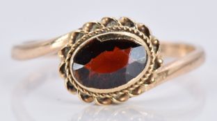 A 9ct gold ring with a garnet, 1.6g, size K