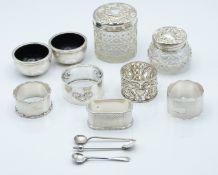 Two hallmarked silver mounted cut glass dressing table pots, hallmarked silver napkin rings, a