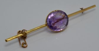 Edwardian yellow metal brooch set with a large oval amethyst of approximately 15ct, 9.3cm long