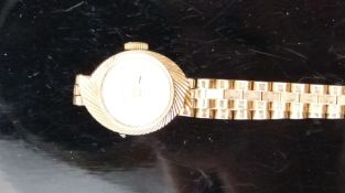 Rotary 9ct gold ladies wristwatch with gold hands and hour markers, silver dial and asymmetric case,