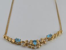 A 9ct gold necklace set with blue topaz and diamonds, 7.5g