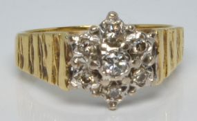 An 18ct gold ring set with diamonds in a cluster, 4.4g, size L/M