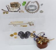 A large filigree butterfly brooch, silver cross and chain, two silver identity bracelets, silver