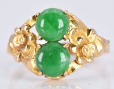 A 14k gold ring set with two jade cabochons with floral embossed shoulders, 3.1g, size O
