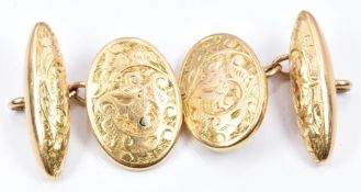 A pair of 15ct gold cufflinks with engraved foliate decoration, 8.3g