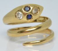 An 18k gold snake ring set with two round cut sapphires and two round cut diamonds, 7.2g, size L