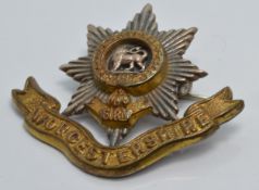 A 15ct gold military brooch set with enamel reading 'honi soit qui mal y pense' (6g) and a