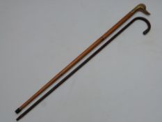 A walking cane with hallmarked silver mounts, London 1916, and a walking stick with brass duck head,