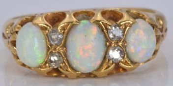 An 18ct gold ring set with opals and diamonds, 4.3g, size I