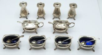 Extensive George V hallmarked silver cruet set comprising four peppers, four open salts with blue