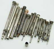 Eighteen white metal and similar propelling pencils, most with engraved detail, largest 9.5cm long