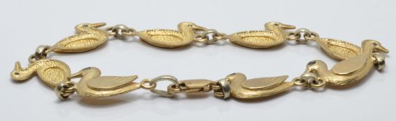 A 9ct gold bracelet made up of duck shaped links set with sapphires, 8g