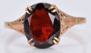 A 9ct gold ring set with an oval garnet, 1.9g, size L