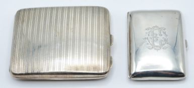 Two hallmarked silver cigarette cases, the larger Birmingham 1931 the other Birmingham 1915,