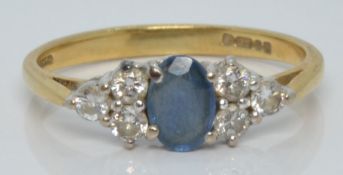 An 18ct gold ring set with a sapphire and six diamonds, 2.3g, size L