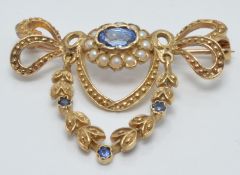 A 9ct gold brooch set with an oval sapphire surrounded by seed pearls and three other sapphires, 3 x