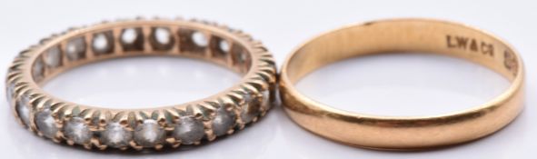 A 22ct gold wedding band/ ring (1.8g, size M) and a 9ct gold eternity ring set with paste (1.8g,