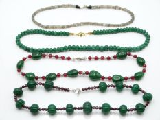 An emerald and jade necklace, quartz and garnet necklace, labradorite necklace, and a quartz