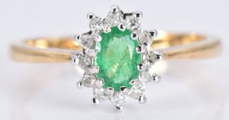 An 18ct gold ring set with an emerald and diamonds, 2.7g, size L