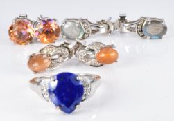 A silver ring set with a pear cut lapis lazuli and zircons and three pairs of silver earrings set
