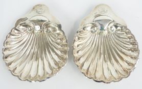 Pair of Victorian hallmarked silver shell shaped dishes raised on three ball feet, Sheffield 1899