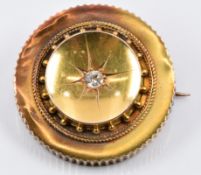 Edwardian 15ct gold brooch set with an old cut diamond, verso a glass compartment, maker's mark WGM,
