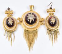 Etruscan Revival pendant set in turn with a foiled garnet cabochon set with old cut diamonds in a