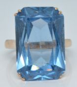 A 14k gold ring set with a large emerald cut blue topaz, 8.3g, size R