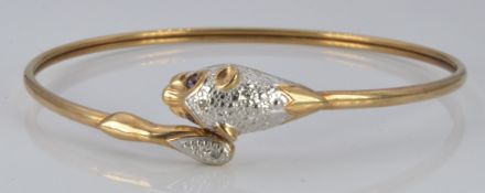 A 9ct gold bangle in the form of a leopard set with amethyst eyes and two diamonds, 7.8g