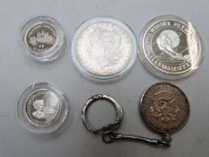 Four various silver coins to include USA 1883 Morgan dollar, Turks and Caicos Islands Olympic 20