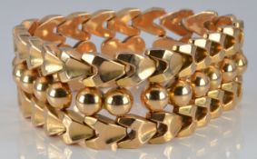 An 18ct gold bracelet made up of spherical and triangular links, 57.4g