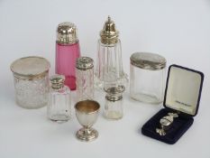 Six various hallmarked silver lidded cut glass items including a cranberry glass sugar sifter,