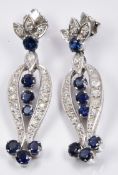 A pair of early 20thC platinum earrings set with round cut sapphires and old cut diamonds, 0.5 x 3.
