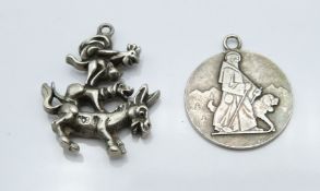 A silver St Christopher marked Huguenin and a white metal charm depicting a donkey, dog, kangaroo