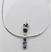 An 18ct white gold pendant set with an oval cut sapphire of approximately 0.75ct and an earring