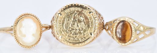Three 9ct gold rings, one set with tiger's eye, one a cameo and a Mexican replica coin, 6.5g, size