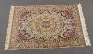 A wool rug with floral decoration on a beige ground, 200 x 125cm