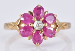 A 9ct gold ring set with oval rubies and a diamond in a flower cluster, 2.6g, size N