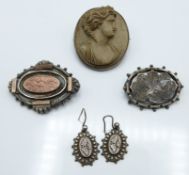 A silver brooch set with a lava cameo (18.8g) , two Victorian silver brooches and a pair of silver