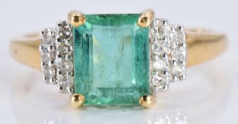 An 18ct gold ring set with an emerald cut emerald and diamonds, 3.5g, size N